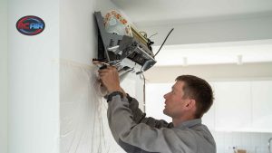 Homeowner asking HVAC technician questions during service visit