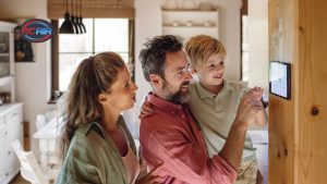 Homeowner programming smart thermostat to save on AC costs