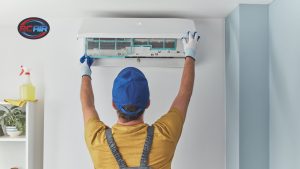 HVAC technician checking air conditioner repair signs