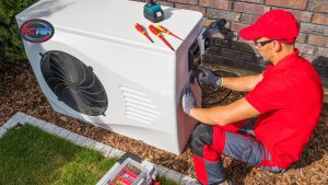 HVAC technician diagnosing common air conditioner problem