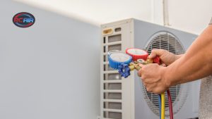 HVAC technician providing routine air conditioner maintenance