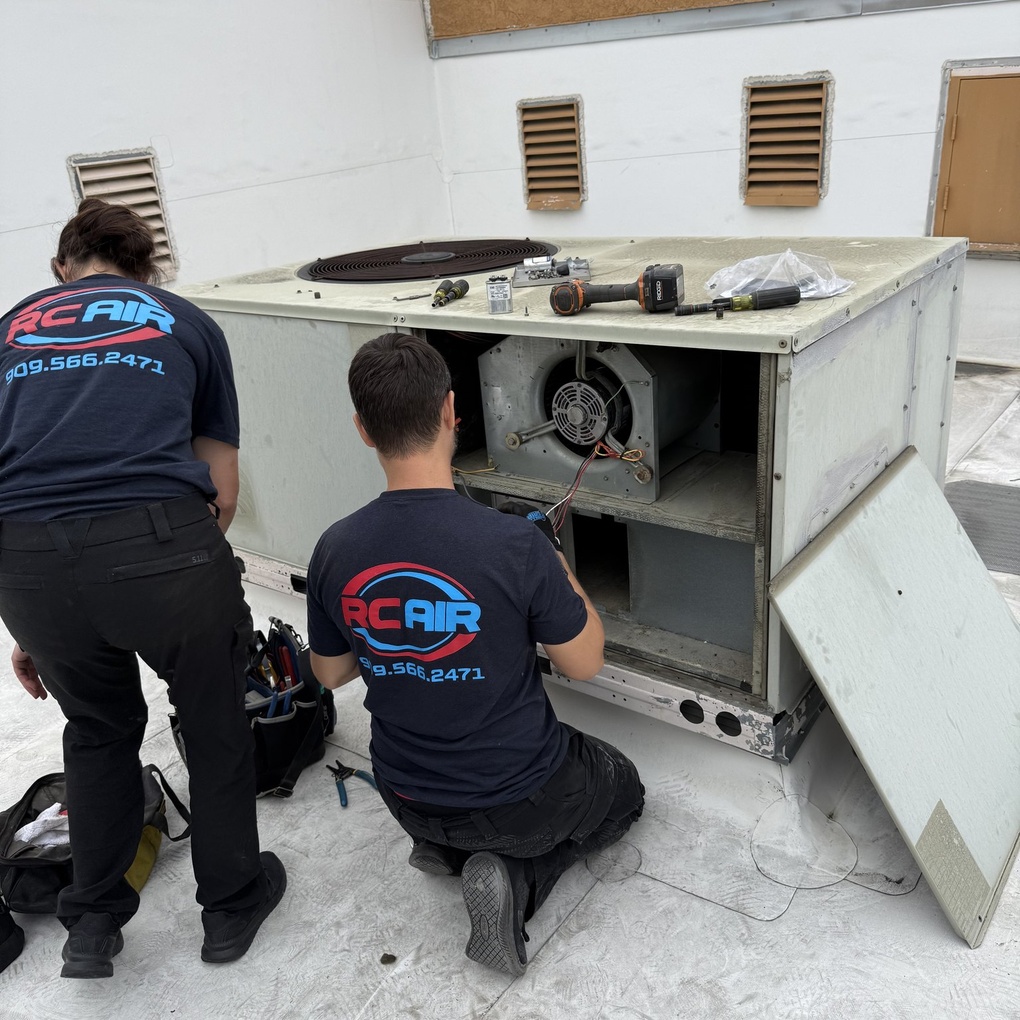 RC Air technician checking an outdoor AC unit during a no-cooling diagnostic