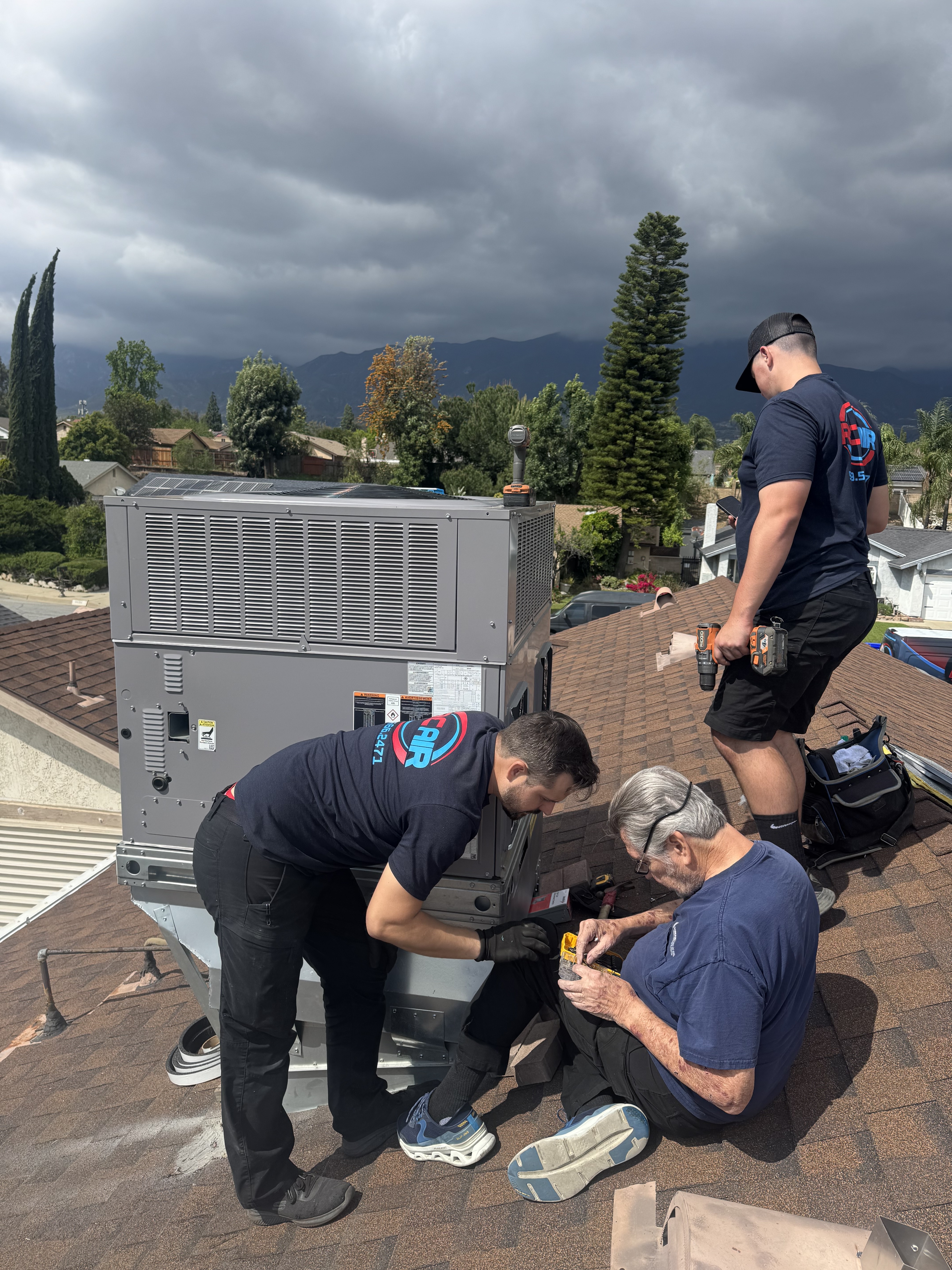 RC Air technicians installing a rooftop HVAC system in Rancho Cucamonga